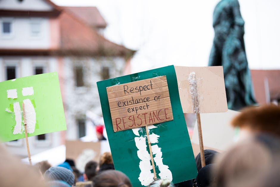 Protestors march with handmade signs in Erlangen, Germany, advocating environmental change.