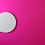 Minimalist pink background with a white speech bubble for creative design projects.