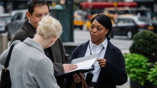 Three professionals discussing documents on a busy city street, showcasing teamwork and collaboration.
