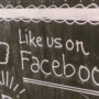 Chalkboard art promoting Facebook engagement with a like us message.