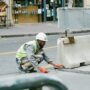 A construction worker operates on a city street in Paris, France, showcasing urban development.