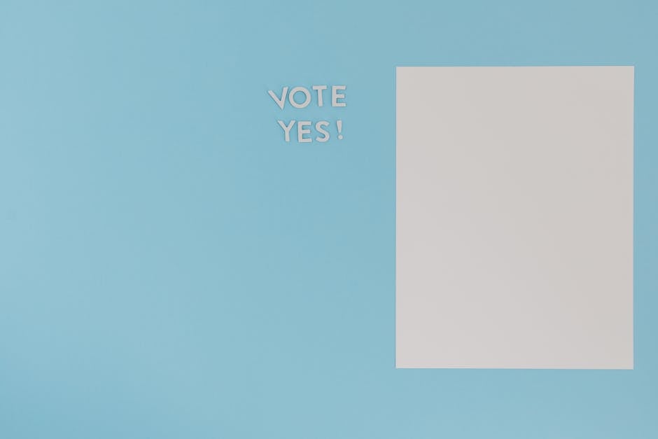 A minimalist concept image featuring 'Vote Yes' text and blank paper on a blue background.