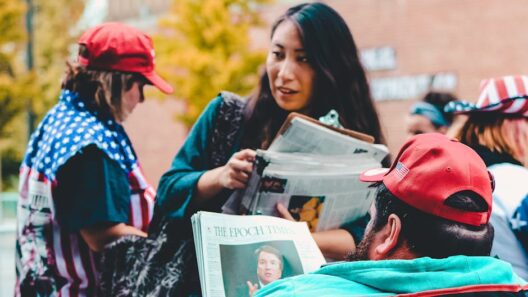 A group of adults reading newspapers outdoors, immersed in political discussions on a vibrant day.