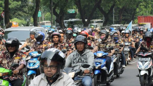 A large group of motorcyclists rallying on a street in Central Jakarta, Indonesia.