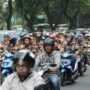 A large group of motorcyclists rallying on a street in Central Jakarta, Indonesia.