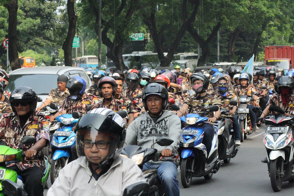 A large group of motorcyclists rallying on a street in Central Jakarta, Indonesia.